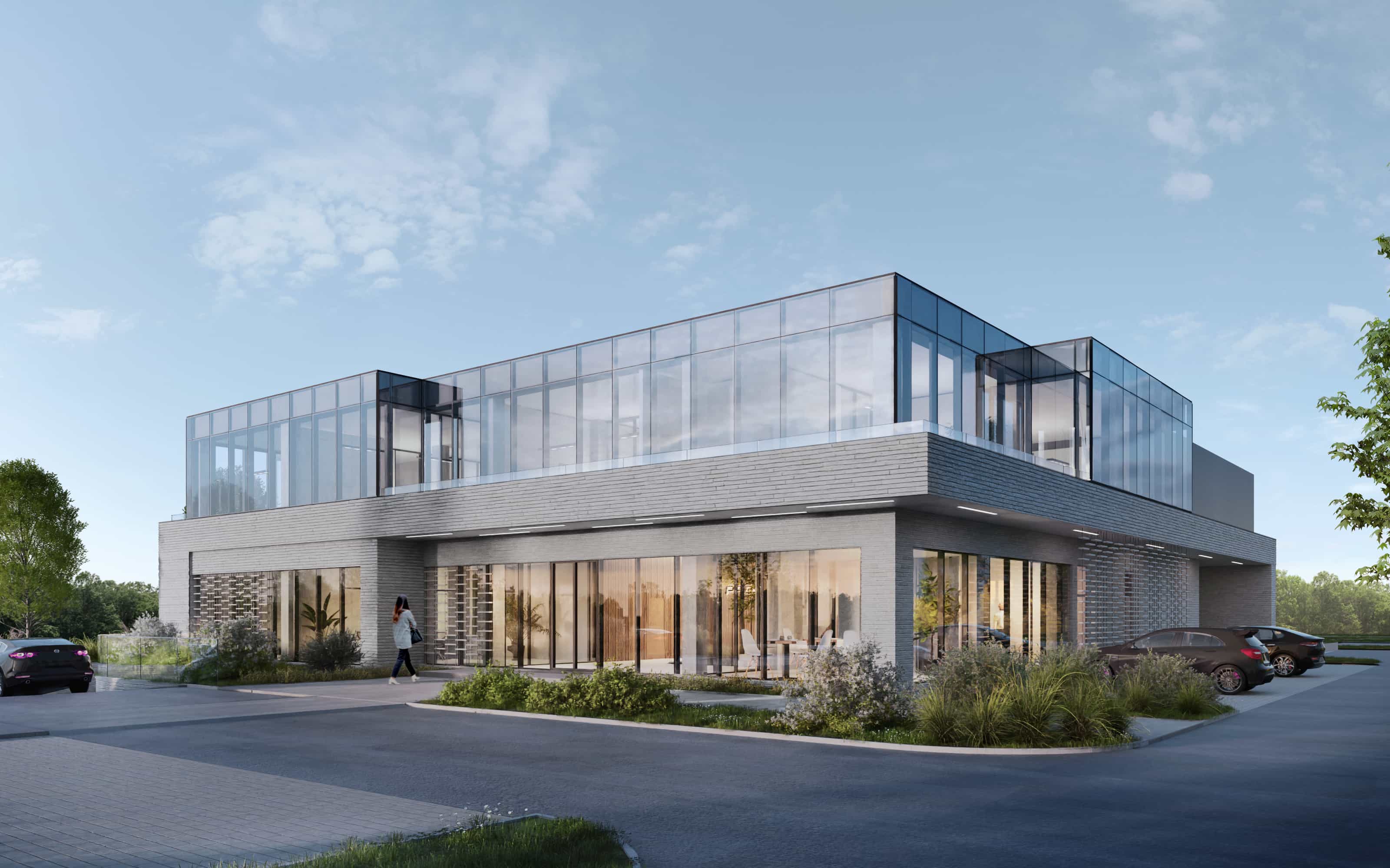 szklany jednopiętrowy budynek z parkingiem wokół biurowca